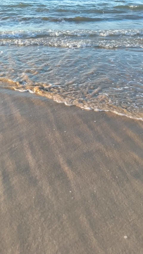 Gentle Ocean Waves on Sandy Beach Vertical View Stock Footage 340379903