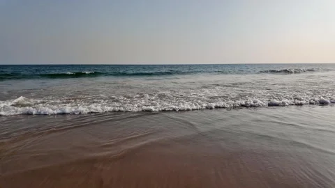 Gentle Ocean Waves on Sandy Beach Shoreline Under Clear Sky Stock Footage 342826674