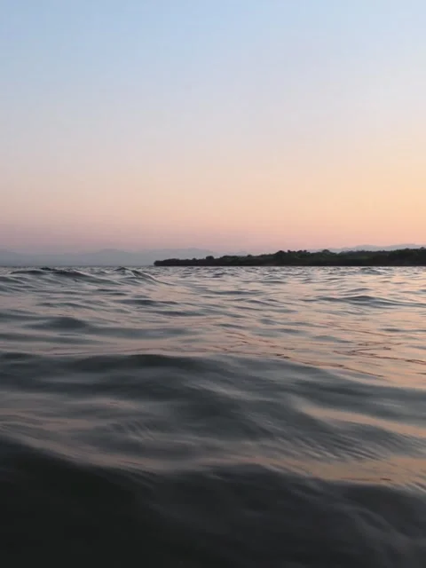 Gentle Ocean Waves at Sunset - Low Angle Water Surface POV Stock Footage 328597317
