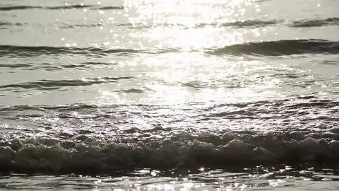 Gentle Ocean Waves at Sunset with Sparkling Reflections on Peaceful Shore Stock Footage 308465653
