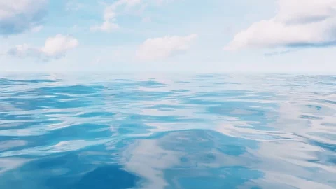 Gentle ocean waves under a clear blue sky with fluffy clouds 스톡 동영상 327524542