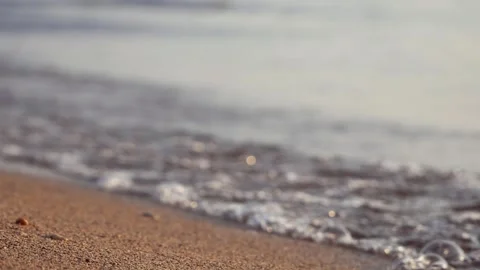 Gentle ocean waves wash softly onto a sandy beach shore. Stock Footage 337413990