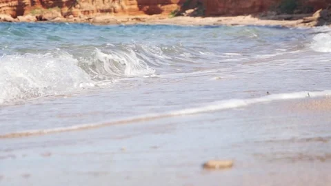 Gentle ocean waves washing onto a calm sandy beach shore. Stock Footage 337407923