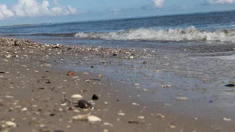 Gentle ocean waves washing over a sandy beach Stock Footage 338124765