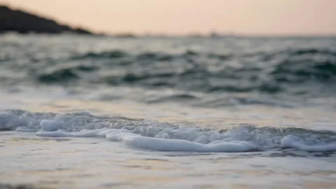 Gentle Ocean Waves Washing Sandy Beach at Sunset 4K Stock Footage 336465370