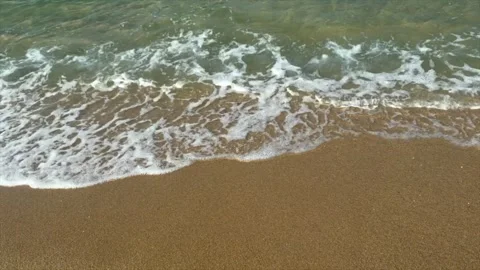 Gentle ocean waves washing onto sandy beach shoreline. Crystal clear seawater Stock Footage 337105113