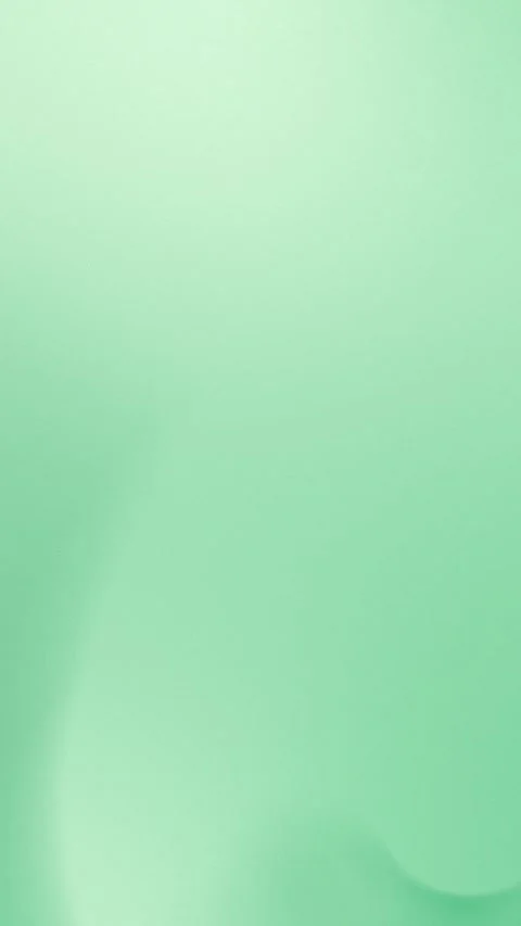 Gentle pastel green gradient with soft curves. Seamless loop background. 4K. Stockbeeldmateriaal 310143537