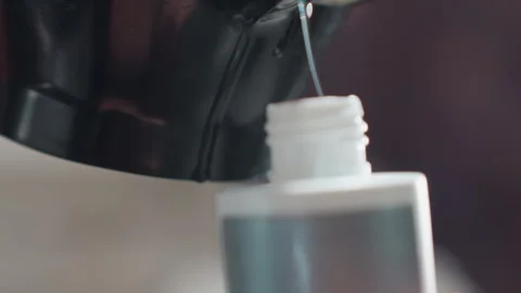 Gentle pouring into narrow vessel, meticulously pouring from bowl into Stock Footage 330602425