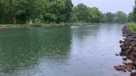 Gentle Rain Falling Down on Water Canal River in Sweden, 4K Stock Footage 135354099