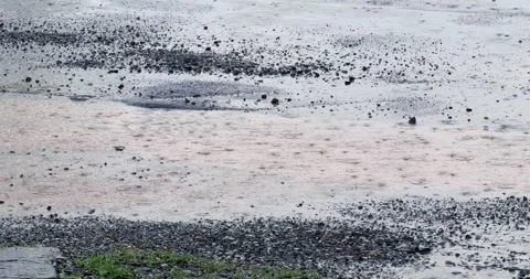 Gentle rain falling on a serene coastal beach under overcast skies in a Stock Footage 337785016