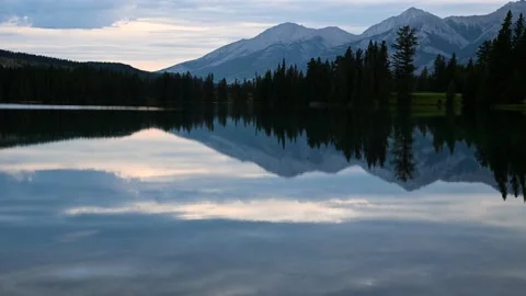 A gentle rain falls into a large mountain pond  Stock Footage 144022441