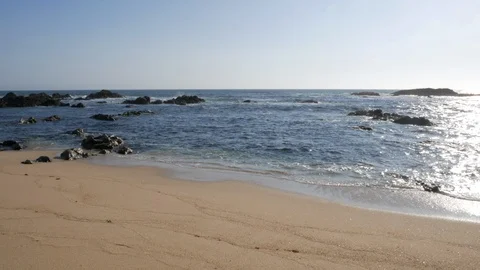 Gentle, relaxing, ocean waves lapping on a golden sandy beach in Portugal Stock Footage 95118464