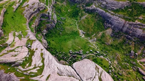 Gentle Right Turn Through an Otherworldly Valley of Giant Green Rock Formations Stock Footage 341236684