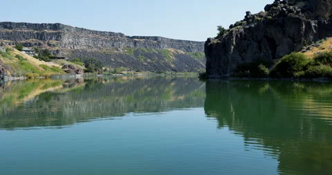 Gentle ripples and beautiful reflection of the Snake River Gorge Stock Footage 215314989