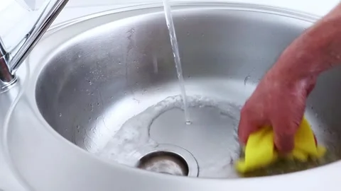 Gentle Scrubbing in Streamed Light: Sink Cleaning in Soft Focus Video stock 313520939