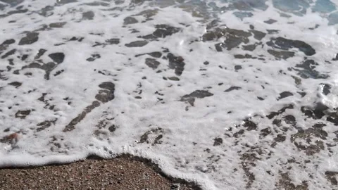 Gentle Sea Waves Gently Lapping on the Sandy Shoreline of a Beach Video stock 313869923