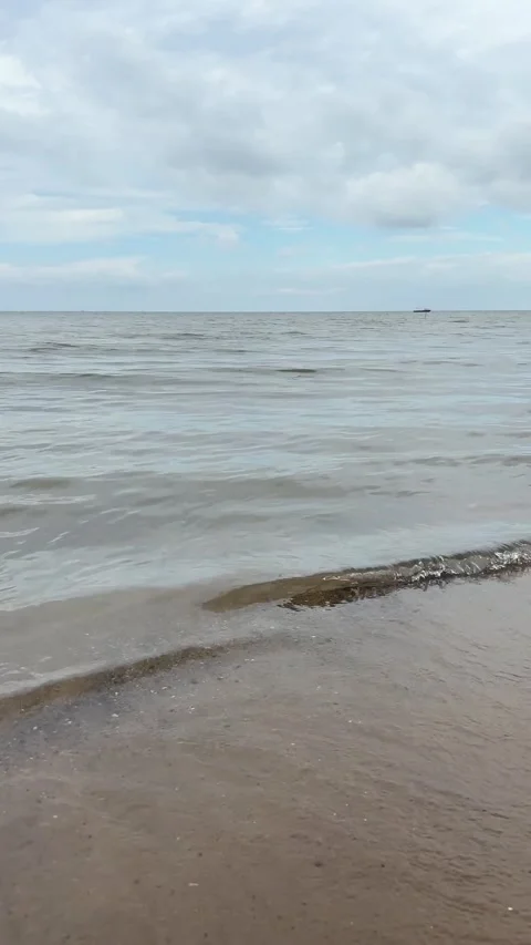 Gentle sea waves hit the sandy beach Stock Footage 292066385