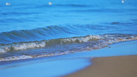 Gentle sea waves reaching the shore on a perfect summer day, serene coastal 4K Stock Footage 335299634