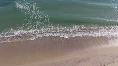 Gentle Sea Waves Rolling onto Sandy Beach | Relaxing Drone View Stock Footage 325720146