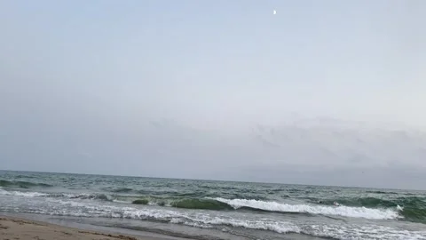 Gentle Sea Waves Rolling Onto Sandy Beach Under Calm Overcast Sky Stock Footage 341915590