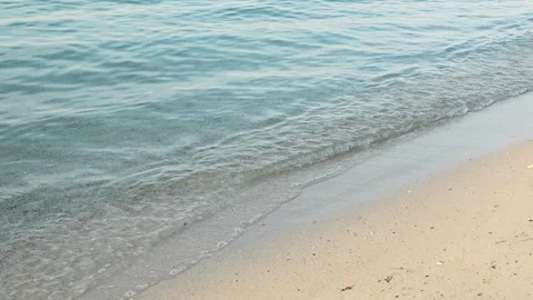 Gentle sea waves on sandy beach at sunny day. Slow motion 4x, 120 fps Stock Footage 294101102