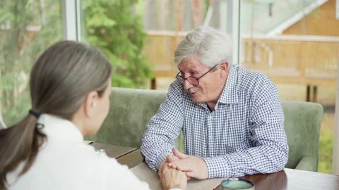 Gentle senior couple supporting each other at table in cafe Stock Footage 142490171