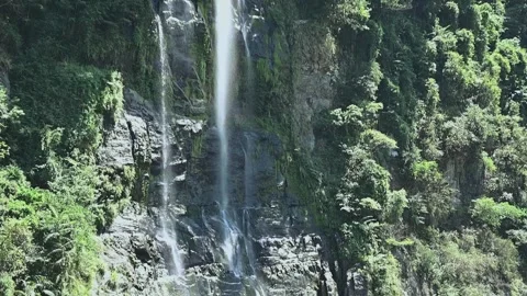 Gentle Silk Like Waterfalls Cascading Down Cliff with Soft Mist in Sunlight.. Stock Footage 340414382
