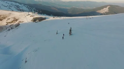 Gentle slopes and bright winter sunshine illuminate skiers, Elevated view Stock Footage 321957522