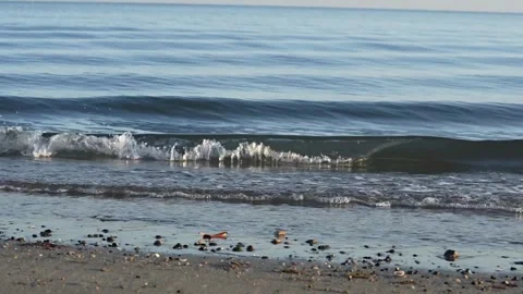 Gentle small waves rolling in on tropical beach Stock Footage 249802889