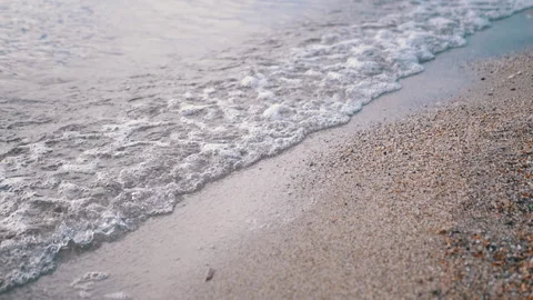 Gentle, Soft Waves are Lapping Gently on the Beautiful Sandy Shoreline of the Stock Footage 312520281