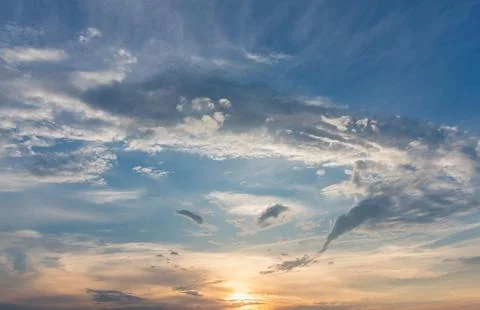 Gentle sunset sky with soft light clouds in delicate vanilla tones. Peaceful  Stock Photos