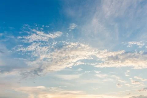Gentle sunset sky with soft light clouds in delicate vanilla tones. Peaceful  Stock Photos