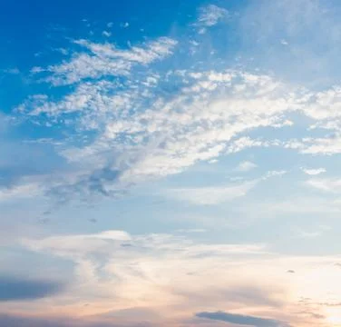 Gentle sunset sky with soft light clouds in delicate vanilla tones. Peaceful  Stock Photos