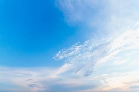 Gentle sunset sky with soft light clouds in delicate vanilla tones. Peaceful  Stock Photos