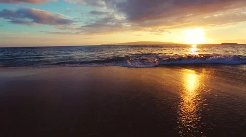 Gentle Surf Breaks on a Beautiful Sandy Beach Sunset. Stock Footage 56024859