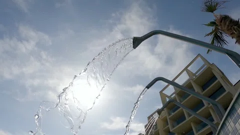 Gentle thermal hydro therapy jet water flowing under the sunny sky near a tro Stock Footage 330694540