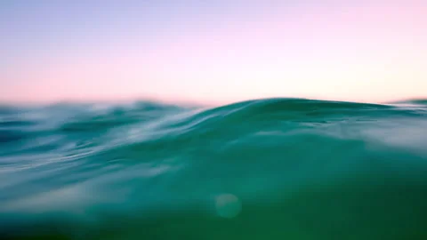 Gentle turquoise waves creating relaxing ripples at sunset Stock-Footage 313269041
