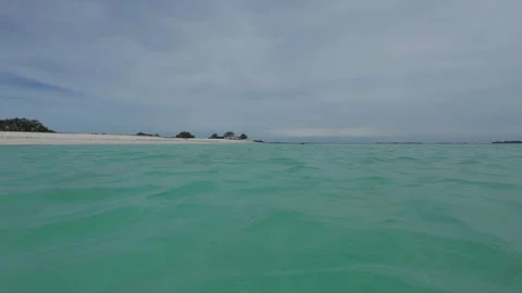 Gentle Turquoise Waves Lapping at the Shore in a Caribbean Paradise Stock-Footage 337655629