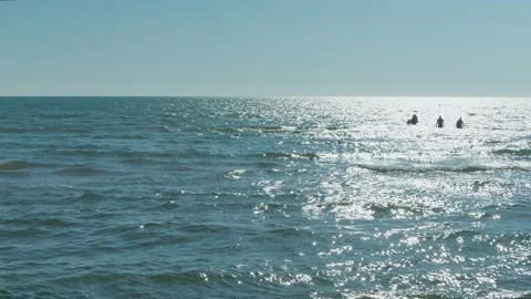 Gentle turquoise waves on the sea in the rays of the evening sun against a blue  Video stock 331664319