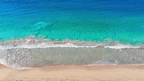 A gentle wave of the blue ocean on a sandy tropical beach. Cruise.  Stock Footage 321148927