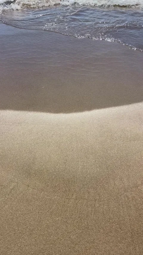 Gentle waves are hitting a sandy beach by summer Stock Footage 337139327