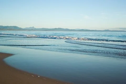 Gentle waves on the beach Stock Photos