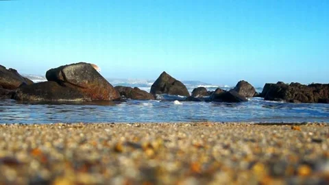 Gentle waves on the beach seen from the shore Stock Footage 233590262