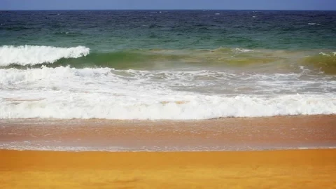 Gentle waves break over the Sand at a Hikkaduwa Beach Stock Footage 153062796