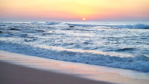Gentle waves breaking on the shore at sunset Stock Footage 272418840