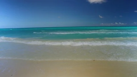 Gentle waves coming in on a white sands beach Stock Footage 86706149