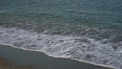 Gentle Waves Covering Beach Sand Stock Footage 240013690