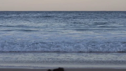 Gentle waves crashing onto beach Stock Footage