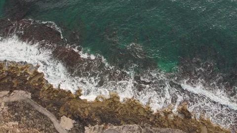Gentle waves lapping against rocks at the shore 스톡 동영상 312269163