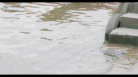 Gentle Waves Lapping Against Stone Steps at Water's Edge Stock Footage 330692144